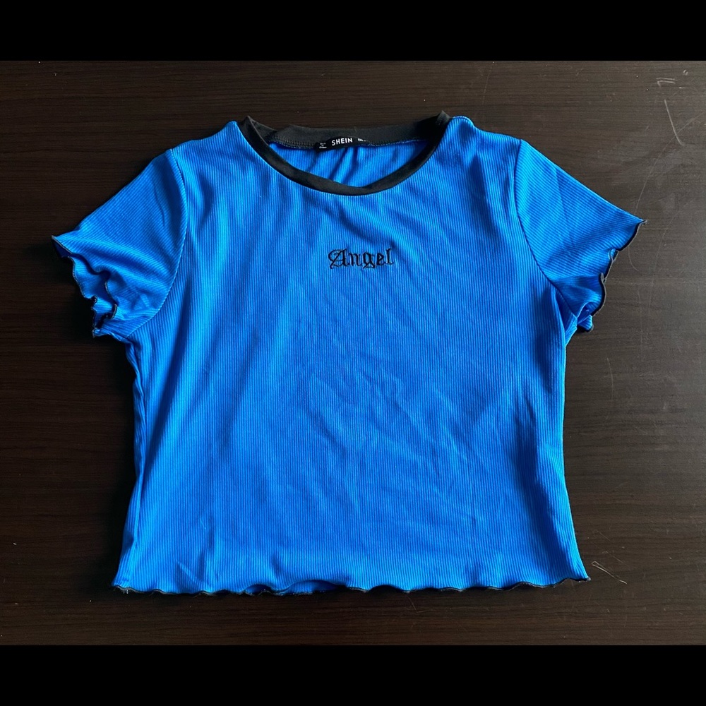 Blue crop top. "Angel" written in black on front.